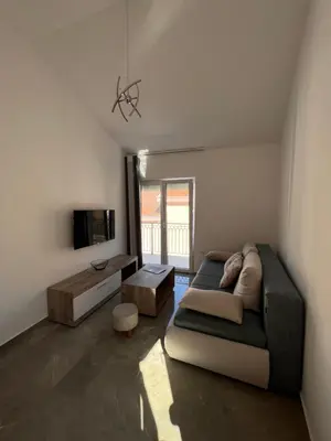 a living room with a couch and a table at Luna Apartment in Kotor