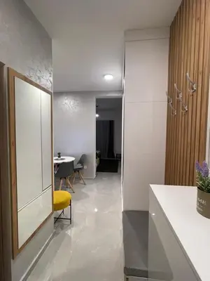 an office lobby with a yellow chair and a table at Apartman Budva 07 in Budva