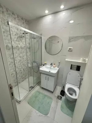 a bathroom with a shower and a toilet and a sink at Apartman VT 2 Central point in Podgorica