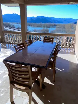 a table and chairs on a balcony with a view at Skadar Lake Apartment -Anja in Vranjina