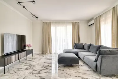 a living room with a couch and a television at Apt 