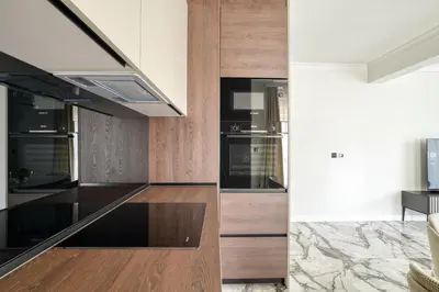 a kitchen with wooden cabinets and black appliances at Apt 