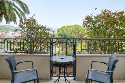 a patio with two chairs and a table on a balcony at Apt 