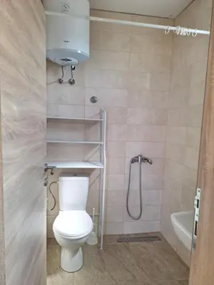 a bathroom with a toilet and a shower and a sink at Apartmani Seaview in Sutomore