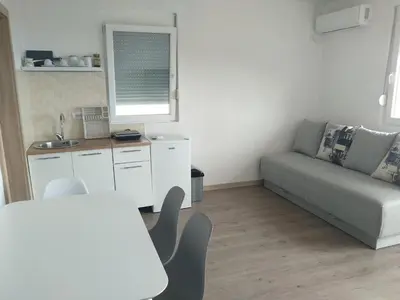 a living room with a couch and a table at Apartmani Seaview in Sutomore