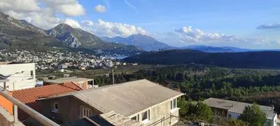 a view of a town with mountains in the background at Apartmani Seaview in Sutomore