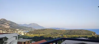 a view of the mountains and the ocean from a balcony at Apartmani Seaview in Sutomore