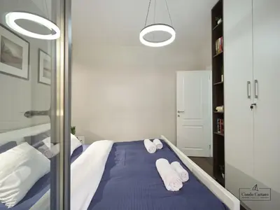 a bedroom with a bed with towels on it at Condo Cattaro in Kotor