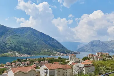 a view of a city and a lake and mountains at Condo Cattaro in Kotor