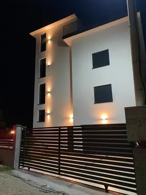 a white building with lights on the side of it at A. Montenegro in Dobra Voda