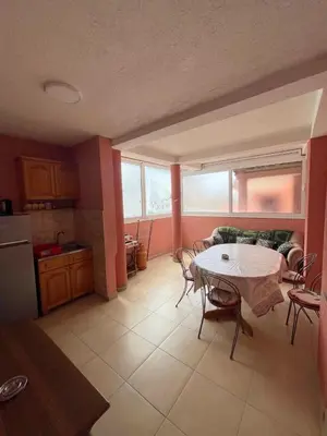 a living room with a table and a kitchen at Apartments Zeneva in Donji Štoj