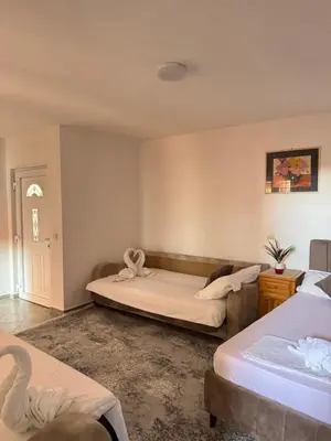 a room with two beds and a bedvisor at Apartments Zeneva in Donji Štoj