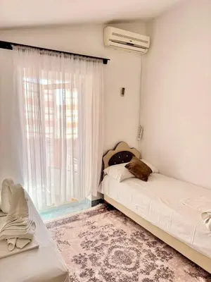 a bedroom with a bed with a cat sleeping on it at Apartments Zeneva in Donji Štoj