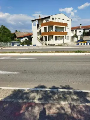a shadow of a building on the side of a street at Apartman Podgorica Stara Varos Vlado in Podgorica