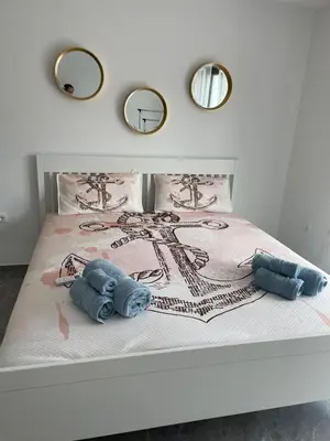 a white bed with two teddy bears on it at Vila Palace 4S next to Plaza in Donji Štoj