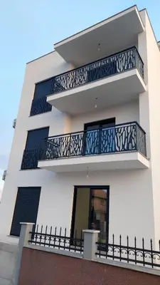 a white building with balconies on it at Vila Palace 4S next to Plaza in Donji Štoj