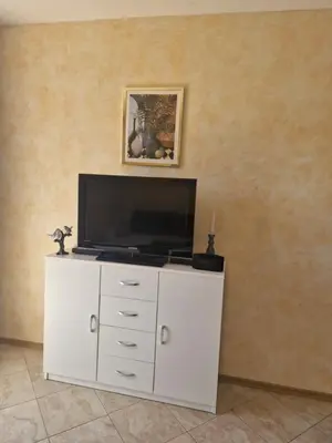 a white cabinet with a television on top of it at Marta apartment in Petrovac na Moru
