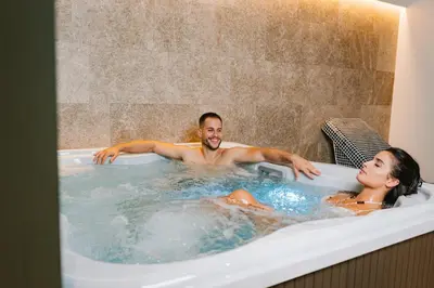 a man and a woman in a bath tub at Kondo Hotel Allure in Budva