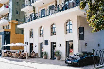 a black car parked in front of a building at Kondo Hotel Allure in Budva