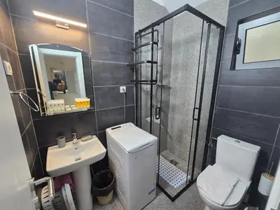 a bathroom with a toilet and a sink and a shower at Olive trees in Budva