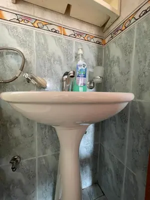 a bathroom sink with a bottle of water on it at Apartmani centar ulcinj in Ulcinj