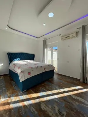 a bedroom with a bed and a large window at Apartmani centar ulcinj in Ulcinj