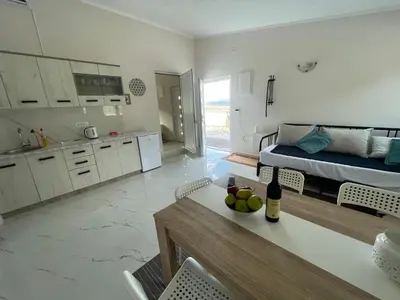a kitchen and living room with a bed and a table at Villa Tunaj new Pool and BBQ in Bar