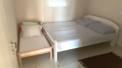 a small bedroom with a bunk bed and a window at Villa Tunaj new Pool and BBQ in Bar