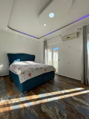 a bedroom with a bed and a large window at Aprtmani centar 2 in Ulcinj