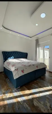 a bedroom with a bed in a room with a window at Aprtmani centar 2 in Ulcinj