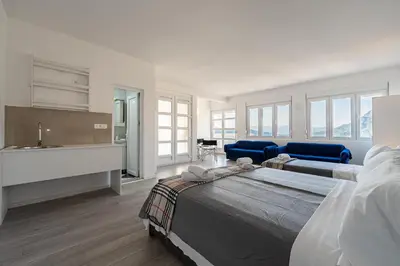 a large bedroom with two beds and a sink at Regina Residence in Budva