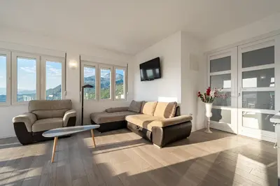 a living room with two chairs and a couch at Regina Residence in Budva