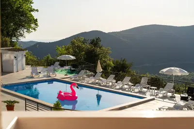 a swimming pool with a pink swan in the water at Regina Residence in Budva