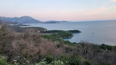 a view of a large body of water with trees at GreenHill-1 Sutomore Apartm in Sutomore