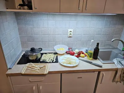 a kitchen counter with a stove and some food on it at GreenHill-1 Sutomore Apartm in Sutomore