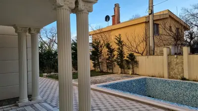 a house with columns and a swimming pool at GreenHill-1 Sutomore Apartm in Sutomore