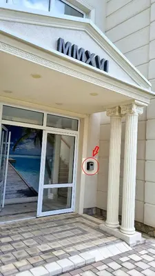a house with a glass door with columns at GreenHill-1 Sutomore Apartm in Sutomore