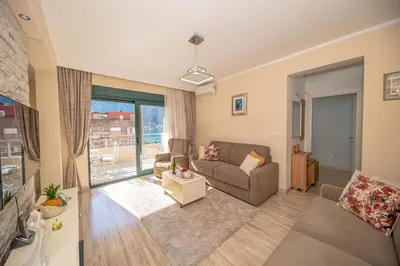 a living room with a couch and a window at Lena apartment 2 in Kotor