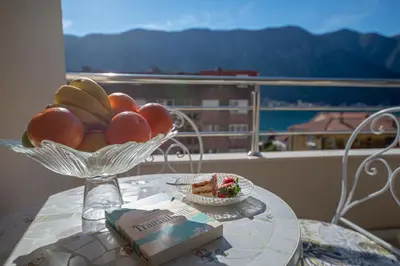 a bowl of fruit on a table with a plate of food at Lena apartment 2 in Kotor
