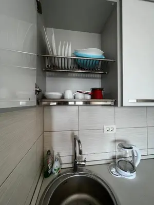 a washing machine in a kitchen with a sink at Paradise Apartments Becici in Becici