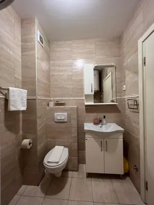 a bathroom with a toilet and a sink at Paradise Apartments Becici in Becici