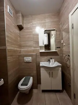 a small bathroom with a toilet and a sink at Paradise Apartments Becici in Becici