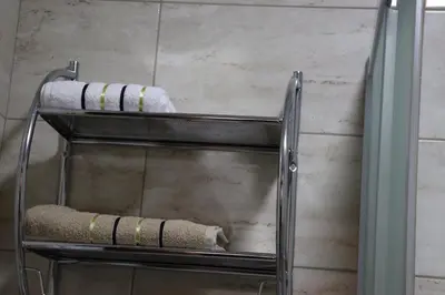 a towel rack in a bathroom with a towel at Dineta Apartment in Ulcinj