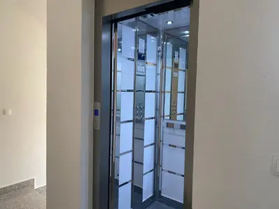 a row of glass doors in a building at Dineta Apartment in Ulcinj