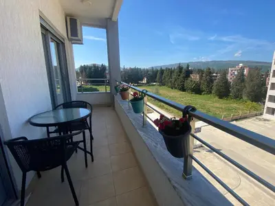 a balcony with a table and chairs and a view at Dineta Apartment in Ulcinj