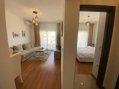 a living room with a couch and a bed at Dineta Apartment in Ulcinj