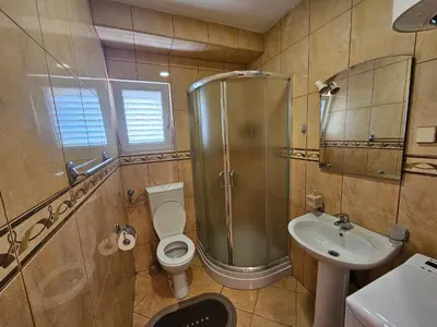 a bathroom with a shower and a toilet and a sink at Dom M Apartments in Budva