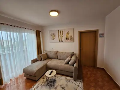 a living room with a couch and a table at Dom M Apartments in Budva