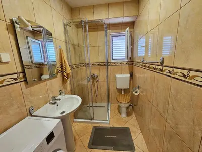 a bathroom with a sink and a toilet at Dom M Apartments in Budva