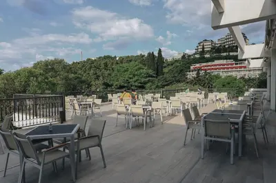 a row of tables and chairs on a patio at Hotel Montenegro in Budva
